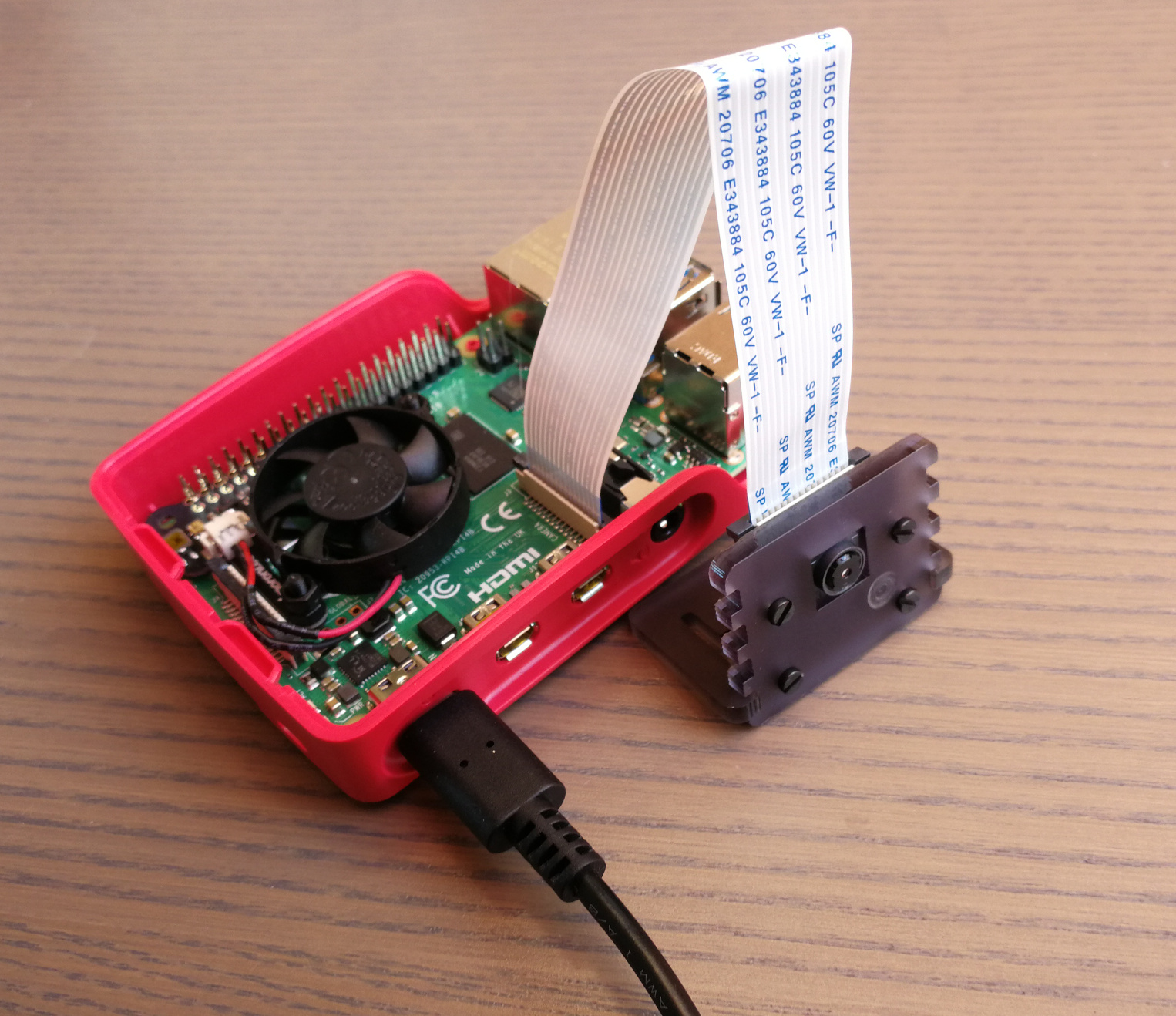 Raspberry 4 with attached Pi camera in barebone housing.