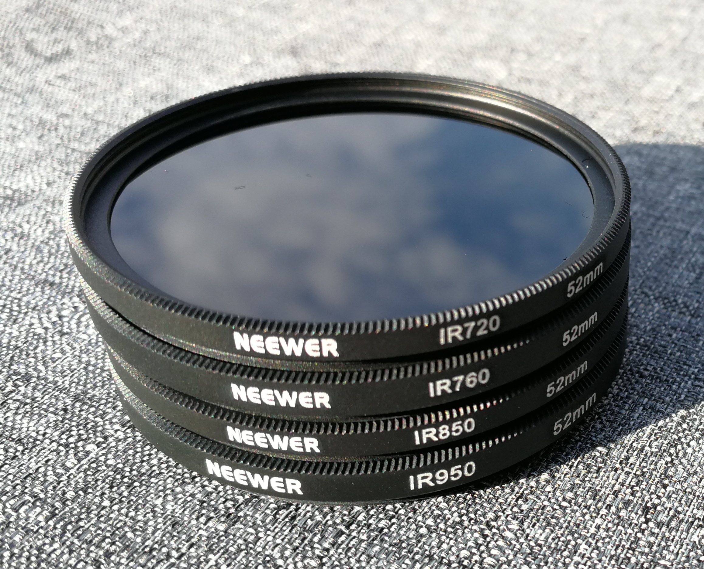 Picture of a stack of infrared light filters for a 52mm camera.