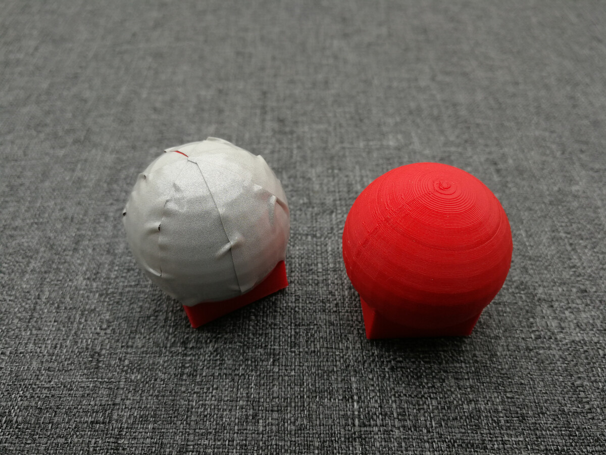 3D printed markers, 30mm spheres with square base. Left marker is wrapped in cheap retroreflective tape.